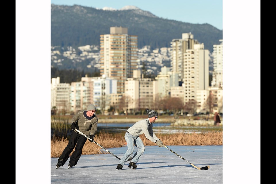 Matt Biso, left, and Johnny Alexandre played shinny on the frozen pond in Vanier Park last January. The glassy ice was blown clean of snow following a cold snap. Photo Dan Toulgoet