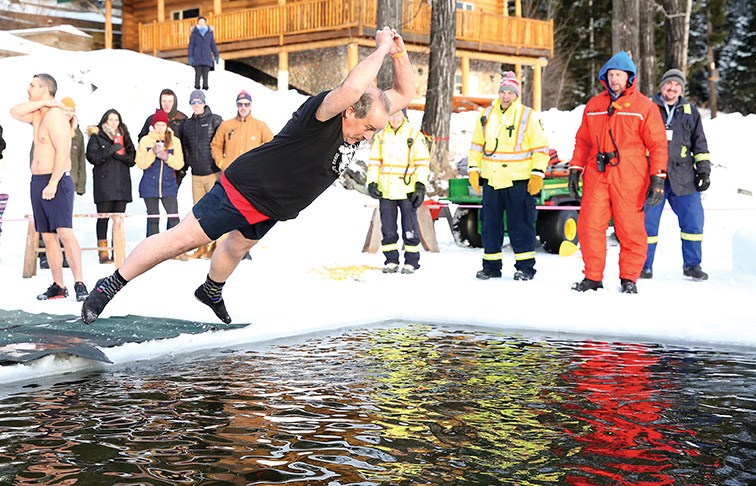 Dale Bull executes a perfect belly-flop into the icy waters of Ness Lake on Monday afternoon for the 17th Annual Polar Bear Dip. The annual event is a fundraiser for Ness Lake Bible Camp and thanks to a last minute donation $7,000 was raised to help send kids to camp. Citizen Photo by James Doyle