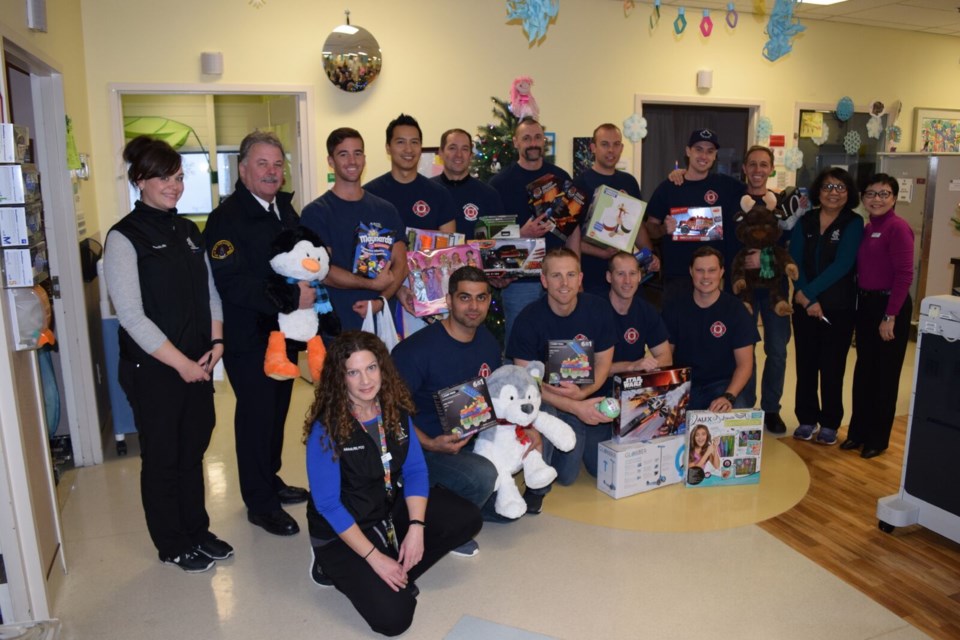 Bearing gifts: New Westminster firefighters recently visited Royal Columbian Hospital to to deliver toys to kids who were in the hospital over the holidays.