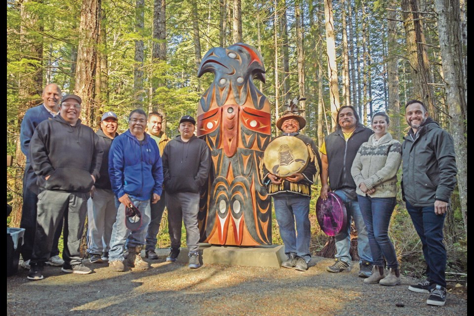 Cowichan Valley Regional District chair Jon Lefebure, left, Malahat councillors Matt Harry, George Harry and Vince Harry, master carver Moy Sutherland Jr., student Troy Harry, cultural drummers Wes Edwards and Jeff Edwards, Malahat lands director Shannon Ralfs and master carver John Marston at the unveiling of the Yos pole.