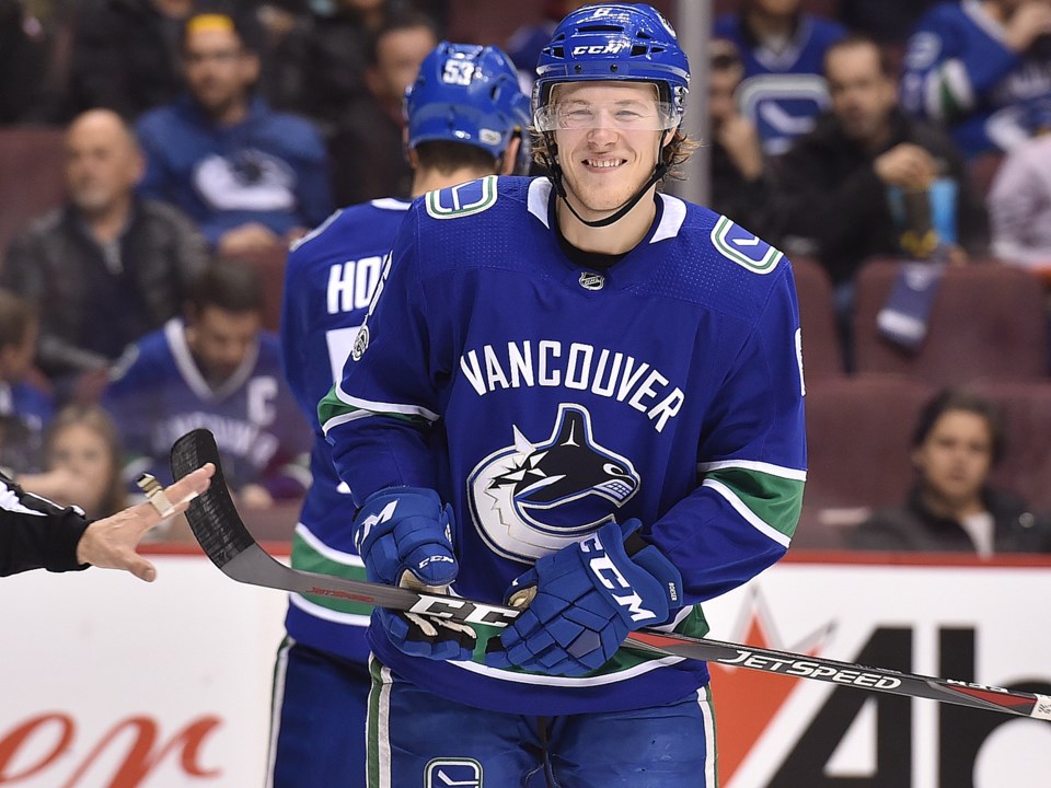 Brock Boeser smiles during a game against the Carolina Hurricanes.