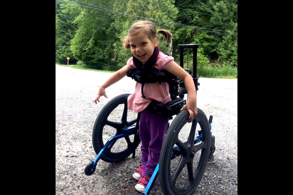 Five year-old Maya Arreaga walks with a walker and enjoys scooting around on her run-trike.