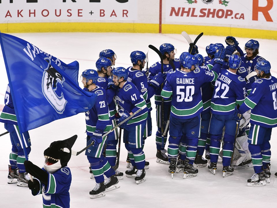 The Vancouver Canucks celebrate a victory with Fin.