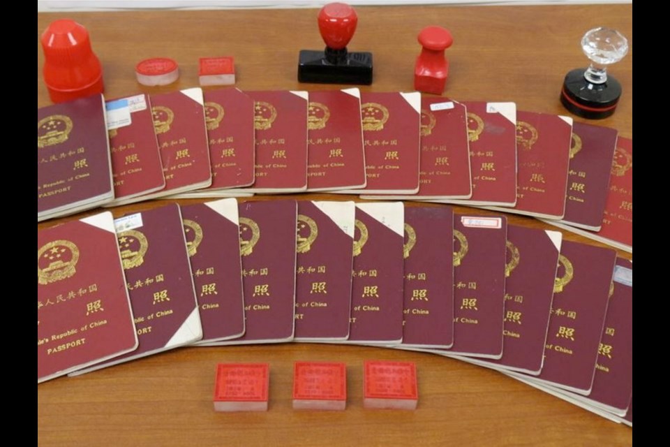 Chinese passports and stamps seized by Canada Border Services Agency.
