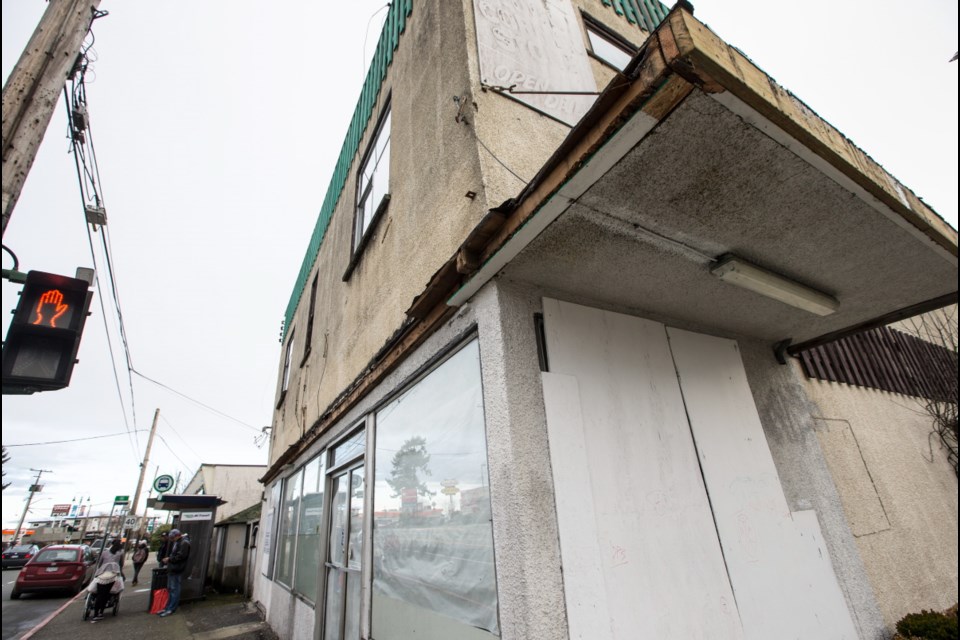A boarded-up former store at Esquimalt Road and Head Street could become the site of a 12-storey mixed-use development.