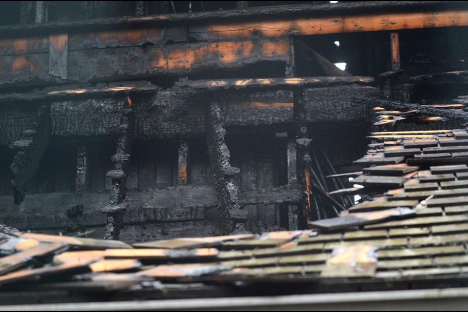 The restored wooden roof of the Fairacres carriage house, a 1911 heritage building on Deer Lake Parkway, was scorched in a fire early Friday morning.