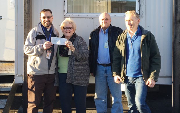 Rev. Peter Smyth of the Mission to Seafarers Centre at Roberts Bank (left) receives a cheque for $500 from Port Community Liaison Committee members (from left) Leslie Abramson, Mark Gordienko and Patrick Thompson.
