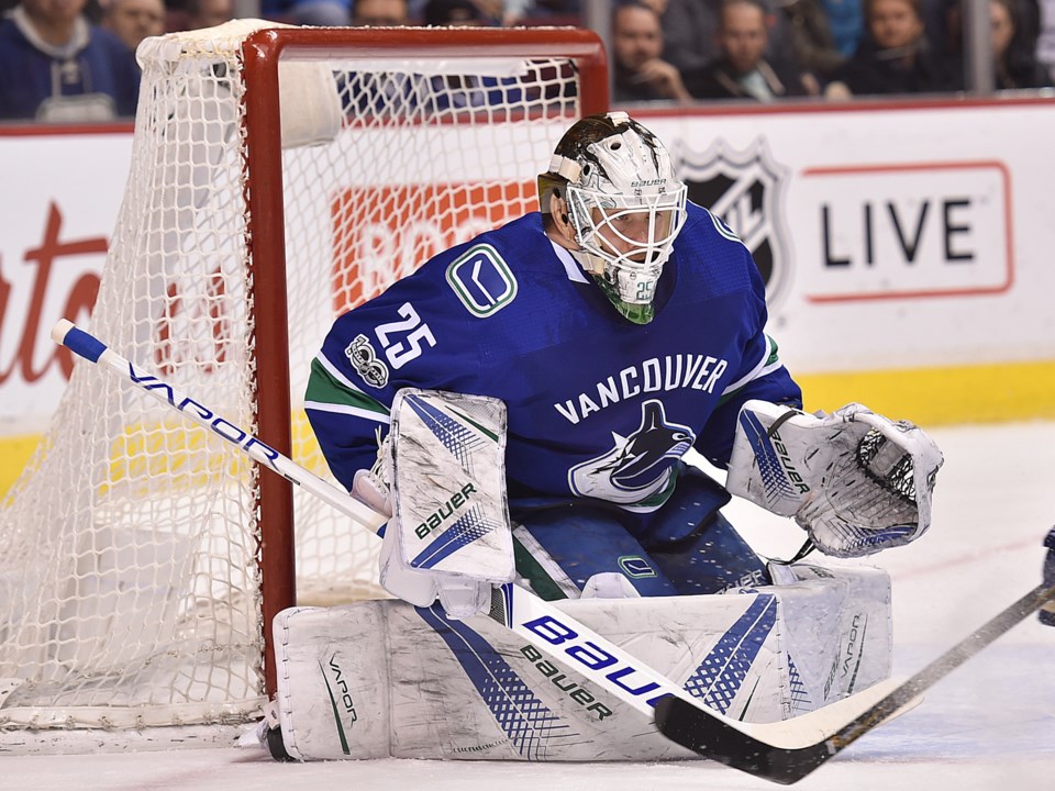 Jacob Markstrom goes down in his butterfly to make a save for the Vancouver Canucks.