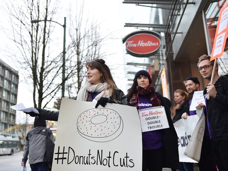 About a half dozen protesters were outside of the Broadway and Laurel location of Tim Hortons to pro