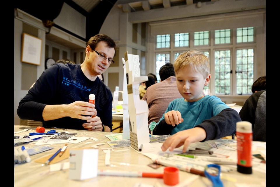 Eight-year-old Adam Pietrzykowski and dad Mario work on their City Structures project at the Burnaby Art Gallery.