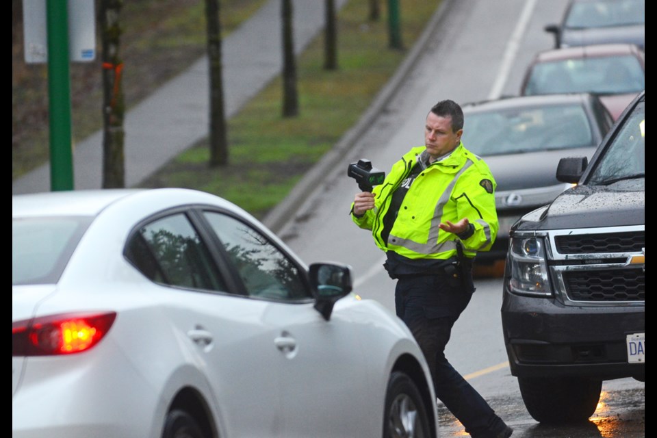 A speeding vehicle is pulled over near a Cariboo Road crosswalk that has seen three pedestrian and cyclist involved crashes since Wednesday.