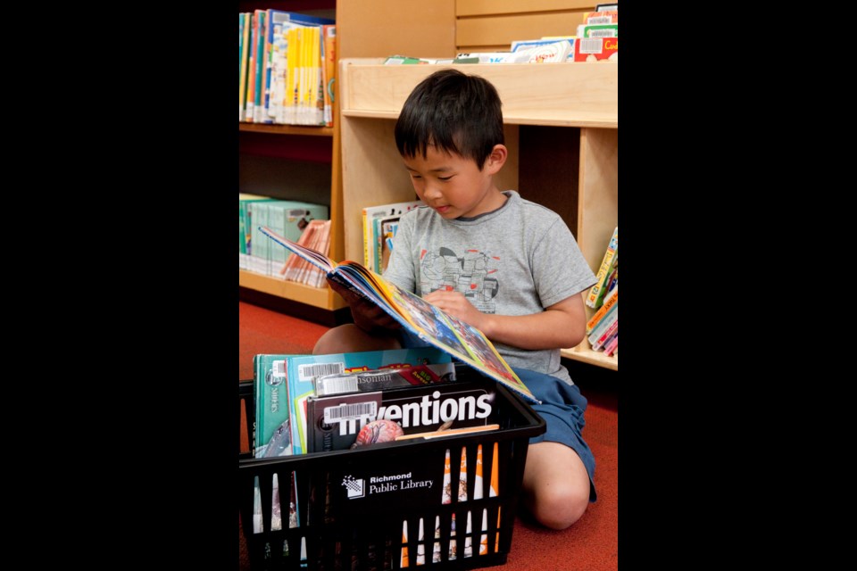 A young boy reads in Richmond Public Library. / Photo courtesy of Richmond Public Library