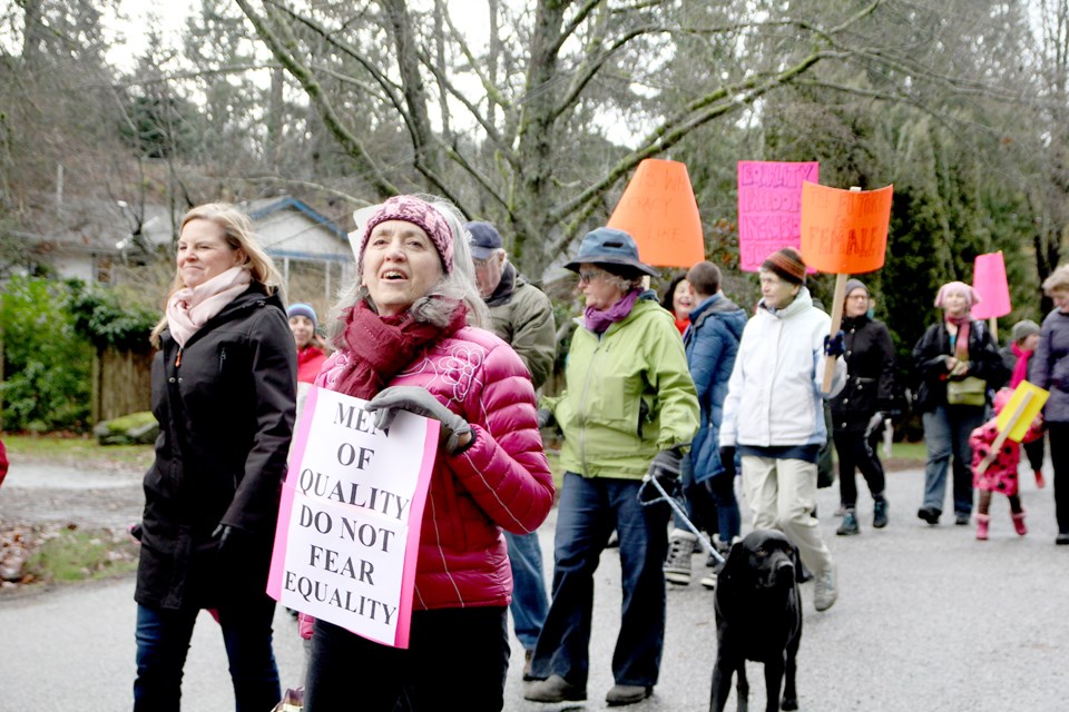 Carol Shatford marches with fellow-islanders towards the lagoon.