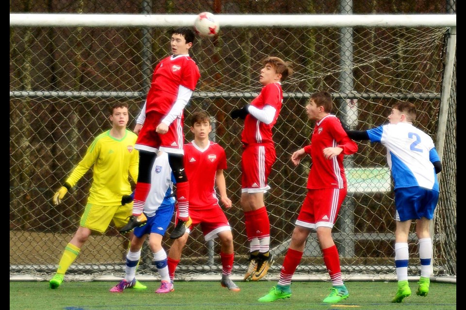 Burnaby District Metro FC under-15 boys kept their unbeaten streak going, topping the South Fraser Delta Selects 1-0 last Saturday. Above, Burnaby's Lazar Kragulji, heading the ball, helps protect the box while goalkeeper Kevin Oliver stands ready, at left. Also helping defend are Tyler Gunasekera, Stefano Dal Sasso and Roan Drepold.