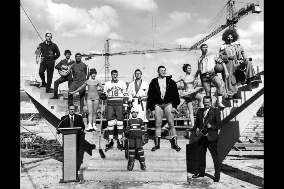 Athletes and performers representing future uses of the Pacific Coliseum standing in the construction site. Harry Jerome (third from left), Karen Magnussen (fourth from left), Barry Watson (fifth from left, in Canucks jersey) and Gene Kiniski (fourth from right). AM281-S8-: CVA 180-5854