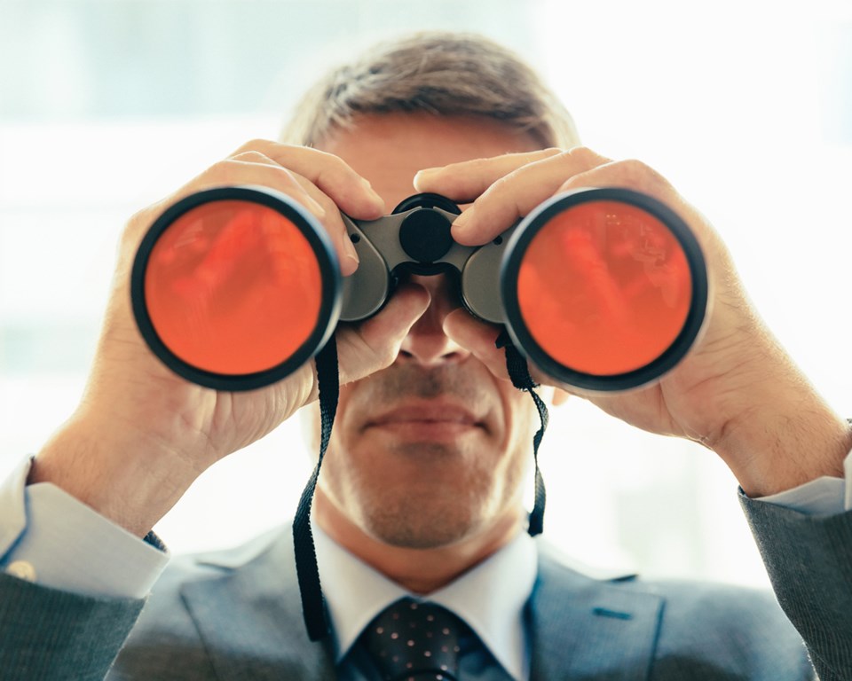 Man looking through binoculars