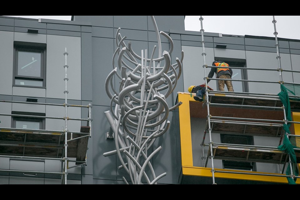 High above the pavement, affixed to the side of Chard Developments' new 15-storey residential building at 819 Yates St., is Victoria's latest piece of public art, Illarion Gallant's aluminum sculpture Tap Route.