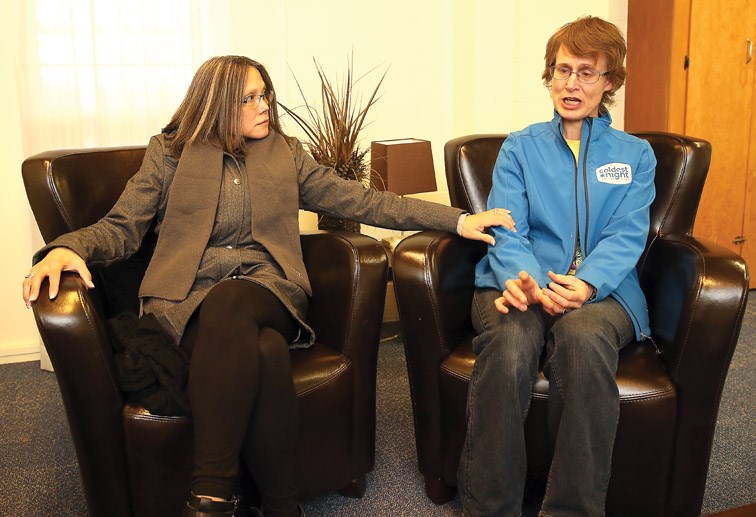 Connie Abe, Executive Director of AWAC, left, comforts an emotional Elda Egan, coordinator of the Coldest Night of the Year walk. Egan's son has mental health issues and is the type of person that this fundraiser is meant to help.