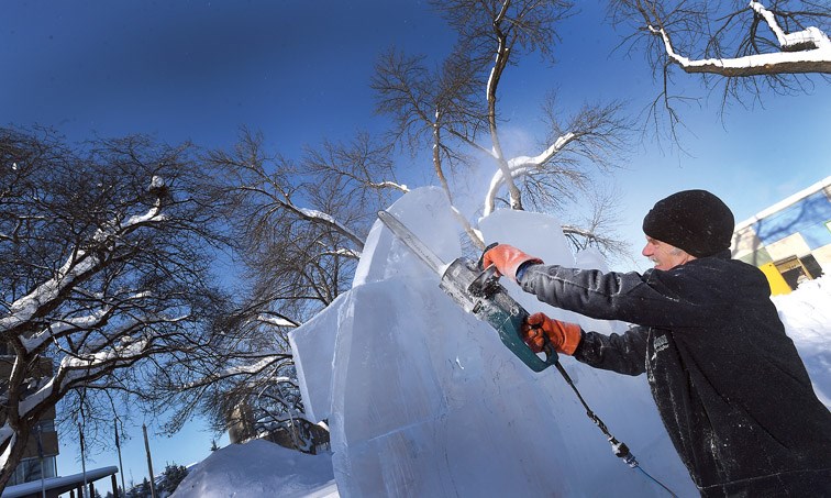 Master carver Peter Vogelaar works on an ice carving in front of City Hall Friday morning in preparation for this Sunday's Downtown Prince George Winterfest that goes from 11 a.m. to 4 p.m.