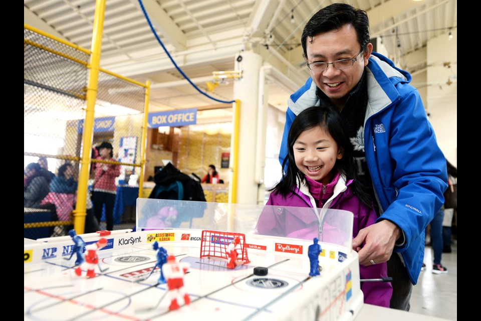 Kevin and Chloe Fung test their table hockey skills during Family Day festivities at River Market.