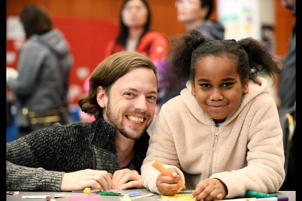 Jeremy Perry and Amayiah Dagami, 7, work on a craft at the Arts Council of New Westminster's booth at the Family Day Fun Zone at Anvil Centre.