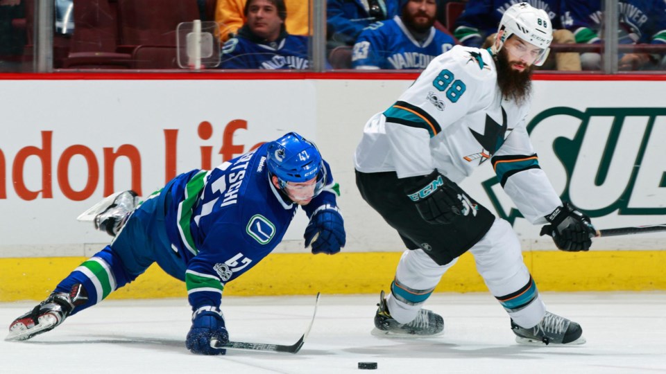 Brent Burns hits Sven Baertschi as the Canucks face the Sharks