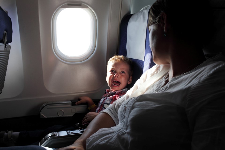 crying child on airplane, iStock