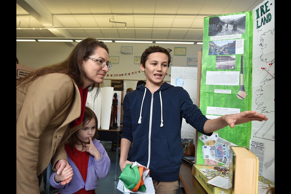 Grade 7 student Keane Joya speaks to VSB trustee Lisa Dominato during a tour he helped lead of Lord Strathcona elementary Friday morning.