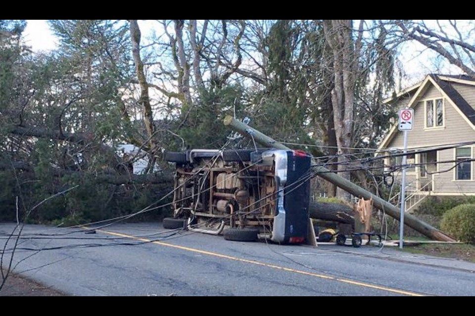 A truck tipped on its side on Union Road in Saanich on Sunday when it became tangled in power lines after a tree fell, bringing down the lines. Feb. 18, 2018