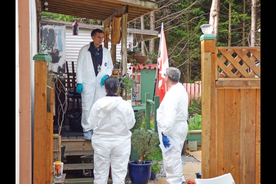 Investigators in October 2014 conversing outside the Selma Park home where 67-year-old Esme LaChance was killed.