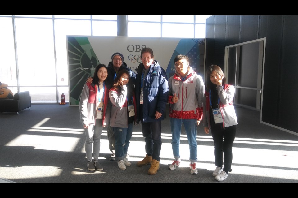 Ken Elmer, back row, and David MacGrotty, centre, are working at the 2018 Winter Olympics in PyeongChang, having previously worked and volunteered at the Games in Vancouver and Sochi. Before the Olympics got underway, they met with local volunteers who are part of the Korean volunteer program.