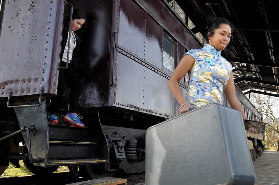Social studies students from Burnaby North Secondary School disembark from the rail car at Port Moody's Station Museum with suitcases packed with immigrants' stories they researched and curated that will be part of a new permanent exhibit at the museum.