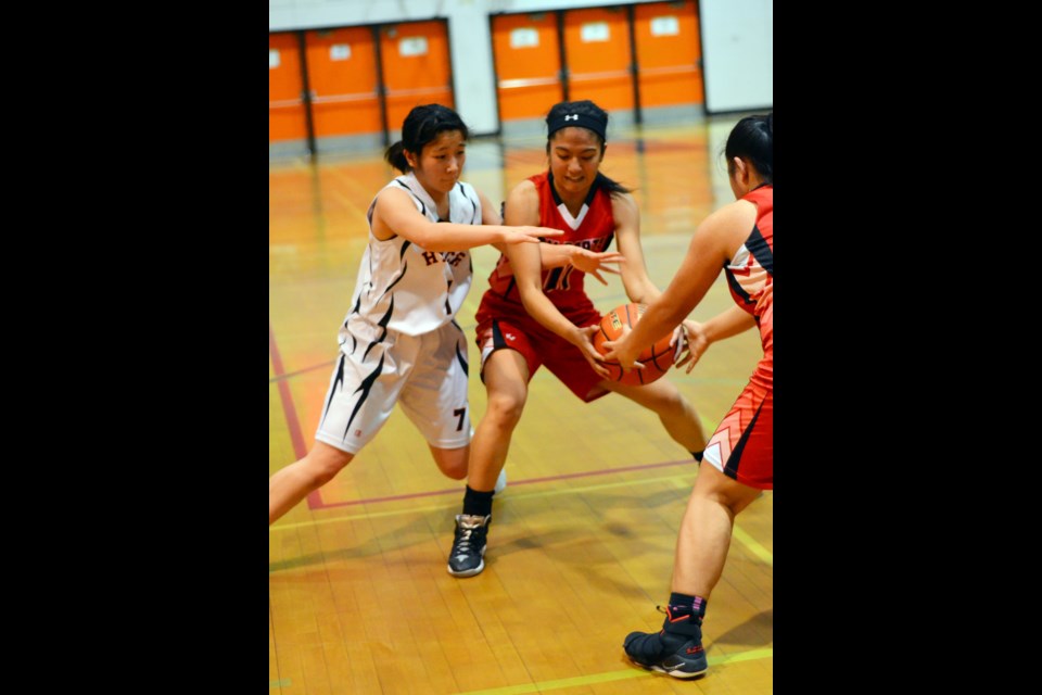 New Westminster's Kanon Imachi, left, clamps down on a Burnaby Central player during recent playoff action at NWSS. The Hyacks have advanced to next week's provincial championships, thanks to finishing third at the Lower Mainlands.