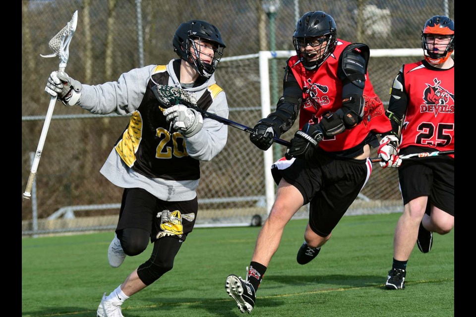 The Burnaby Devils’ Max Miller, centre, pursues a PoCo ball carrier during early round action at the under-18 field lacrosse provincial tournament, held two weeks ago at Burnaby Lakes. The Devils marched all the way to the final before falling 17-8 to Mission.