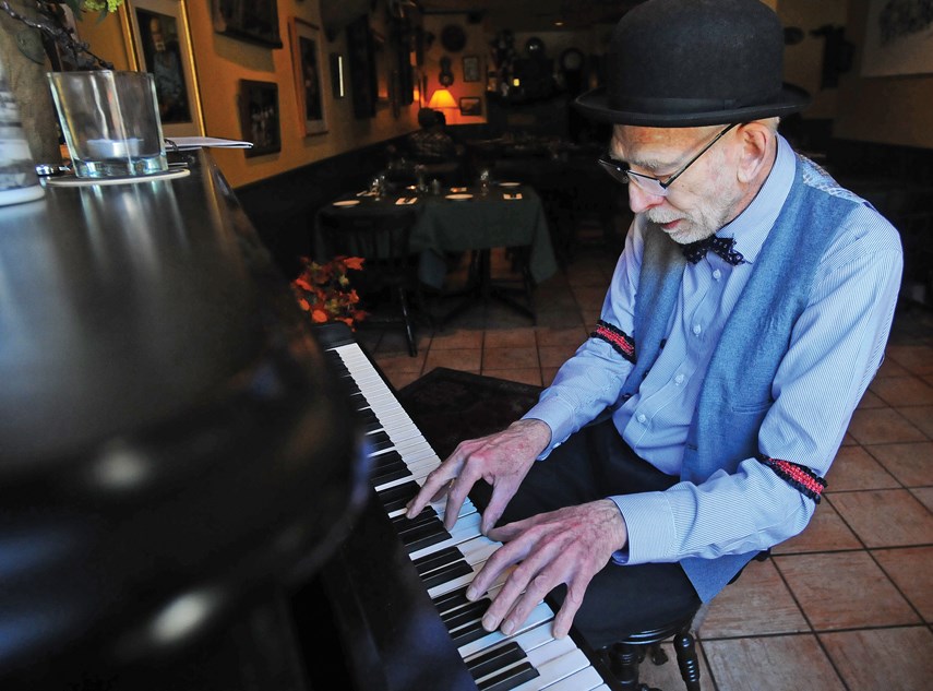 Johnny Piano tickles the ivories on a Fischer upright, built in New York in 1887, that sits in the entrance of the Jagerhof Restaurant.