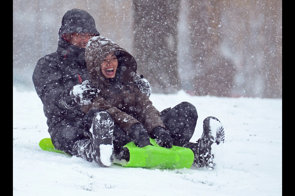 Hartley and Yim Facultad prepare to zip down a hill at Ron McLean Park in South Burnaby during a dump of snow Friday.