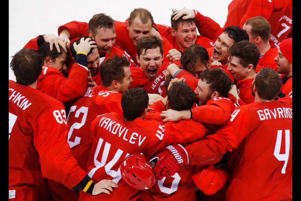 Olympic athletes from Russia celebrate after winning the men's gold medal hockey game against Germany, 4-3, in overtime at the 2018 Winter Olympics, Sunday, Feb. 25, 2018, in Gangneung, South Korea.