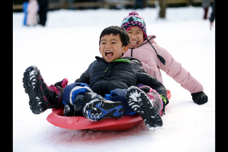 Andrew and Hezel Evalle toboggan in Queen's Park.