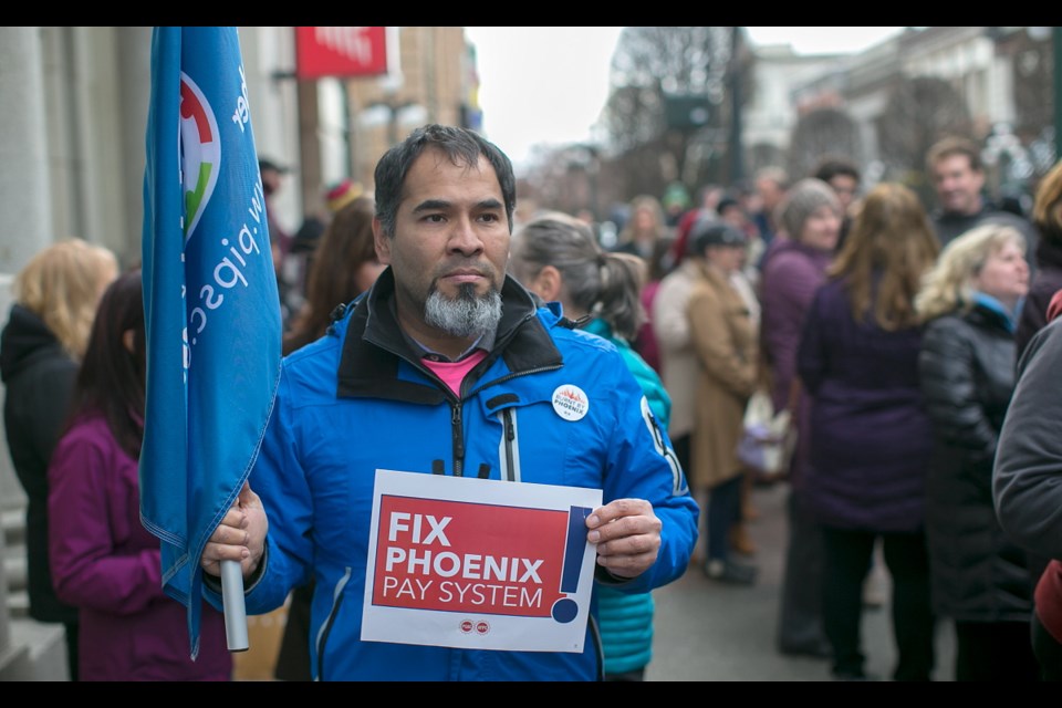Efrain Andia stands with others during the Phoenix Day of Action rally on Government Street in Victoria on Wednesday Feb. 28, 2018.