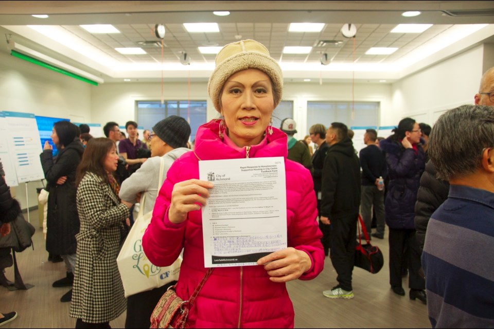 Kehui Au, a resident living near the proposed site, showed her support by filling out a questionnaire during the open house. However, many other residents opposed the project due to safety concerns. Daisy Xiong photo