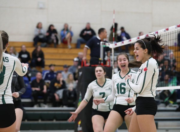 Douglas College's Vania Oliveira, at right, celebrates a point with teammates, from left, Vicki Schley and Kendra Potskin. Oliveira, a second-year player with the Royals, was chosen the tournament MVP in the Royals' provincial win.