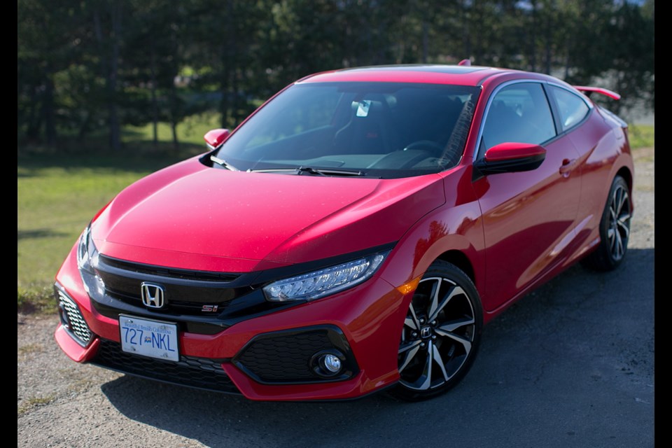 The Civic Si gets a more aggressive grille and wider tires than the regular Civic &mdash; as well as the integrated rear spoiler.