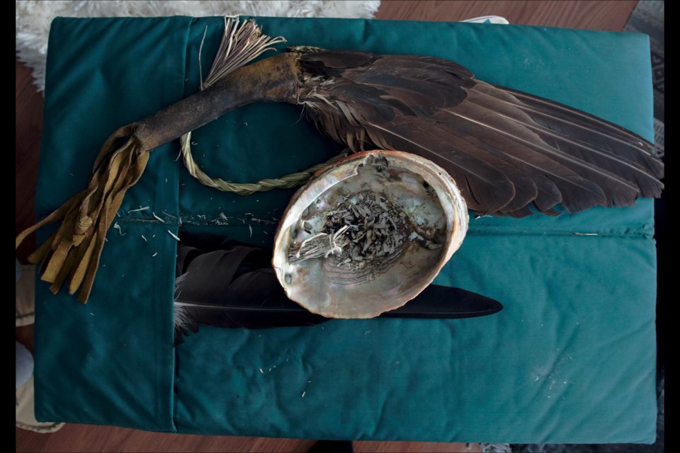 An eagle fan, smudge bowl, sweet grass and sage. These items are for ceremonial use and are an integral part of traditional medicine, spirituality and healing. Reprinted from The Lancet, https://doi.org/10.1016/S0140-6736(18)30468-9, Palmer, Picturing health: health advocates for Indigenous communities in British Columbia, Canada, Copyright (2018), with permission from Elsevier