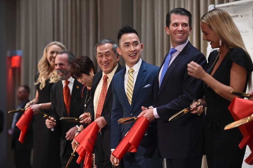 Amid protests outside, members of the Trump and Joo Kim Tiah families took part in the ribbon cuttin