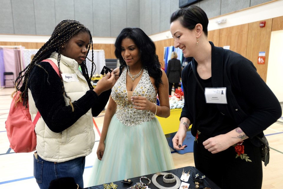 18-year-old Yaris Palacios, centre, her friend Ayerin Nunez and her personal assistant for the day, Amanda Fortin, check out jewellery.
