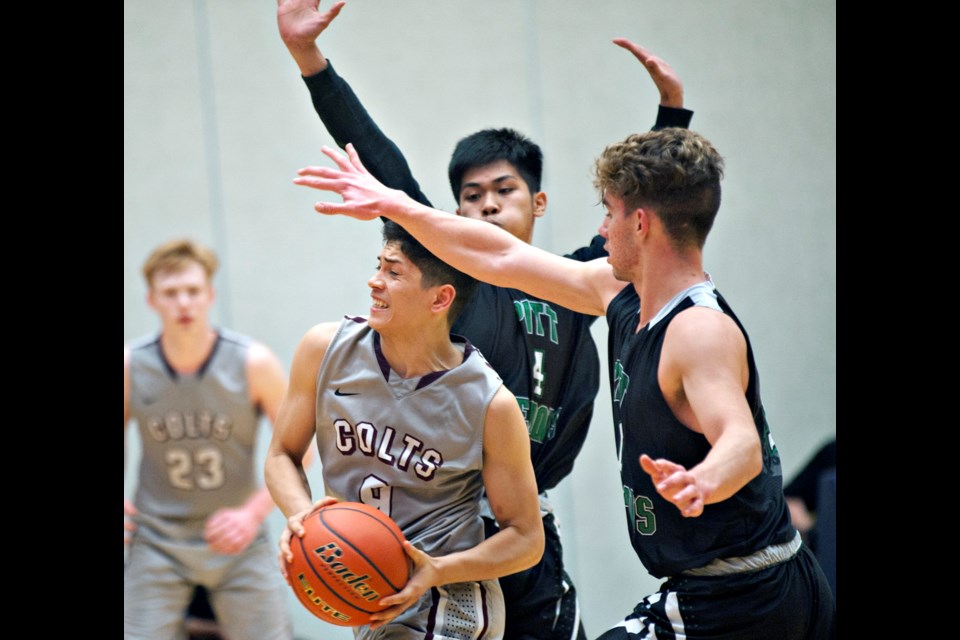 Murad Mohammed works his way to the basket during Thursday's provincial 3A quarter-final game against Pitt Meadows at the Langley Events Centre. Mohammed scored the winning basket a day earlier when the 14th seeded Colts stunned No. 3 Argyle.