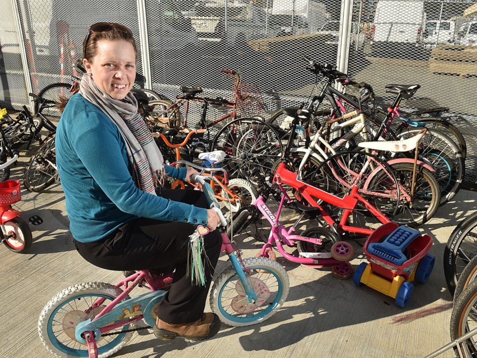 Sarah Willie, a city zero waste manager, with a bicycle dumped at the city’s new recycling depot on