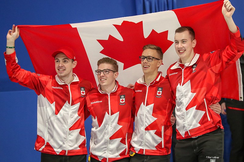 Coquitlam's Zachary Curtis, second from right, celebrates with his Team Tardi teammates after they won the world junior men's curling championship, Saturday in Aberdeen, Scotland.