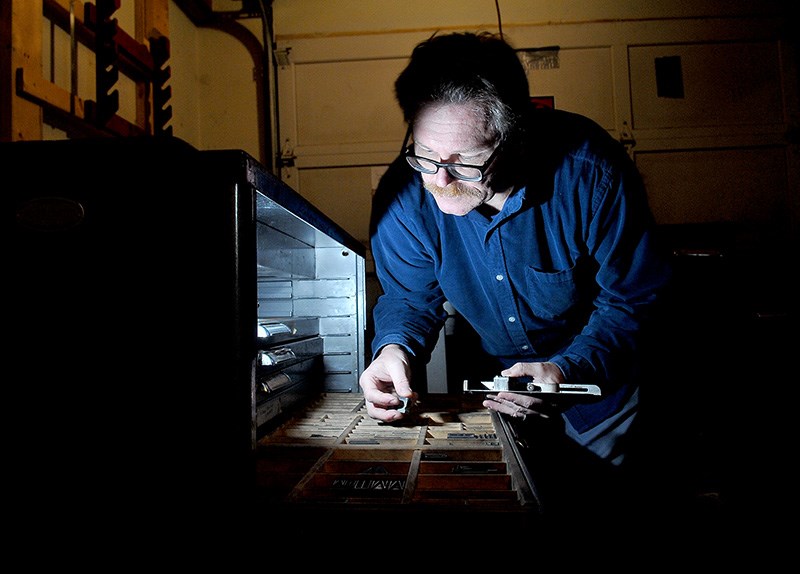 MARIO BARTEL/THE TRI-CITY NEWS
Markus Fahrner sorts through blocks of metal fonts he uses to create books and posters on his 1914 printing press in the garage of his Port Moody home.