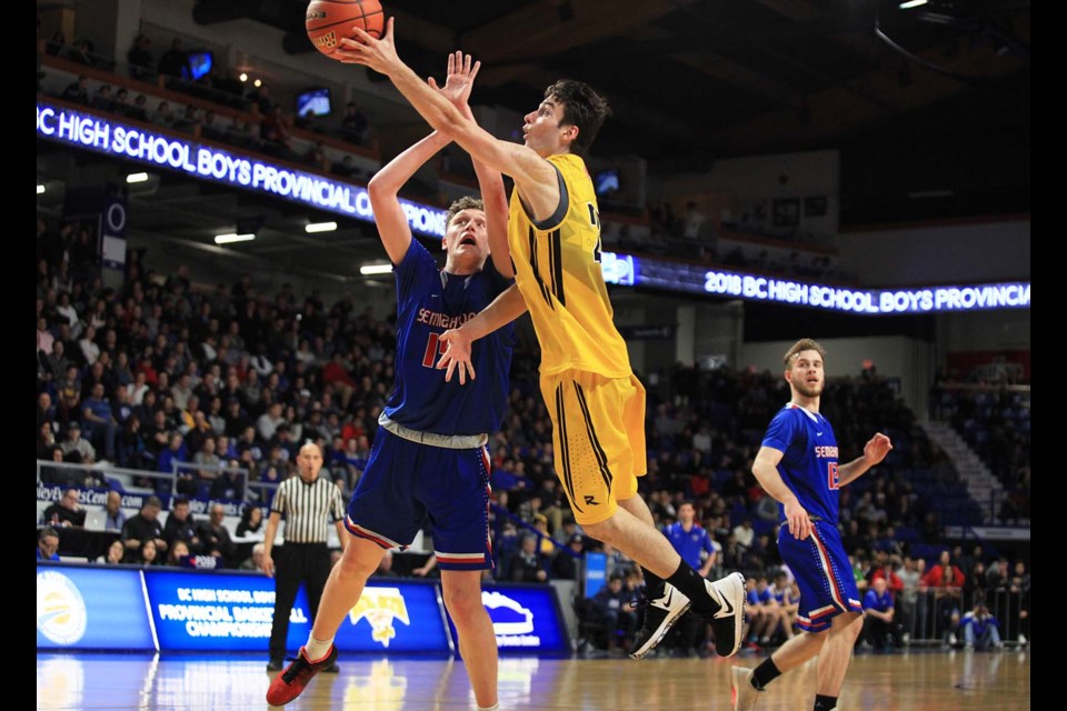 Slipping past Semiahmoo's Adam Paige for a layup is Burnaby South's Jusuf Sehic in Saturday's B.C. 4-A senior boys basketball championship final. The Rebels defeated Semiahmoo 80-72 to cart off the school's first hoop title since 1979.